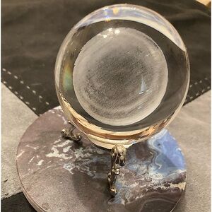 Crystal ball with engraved Saturn